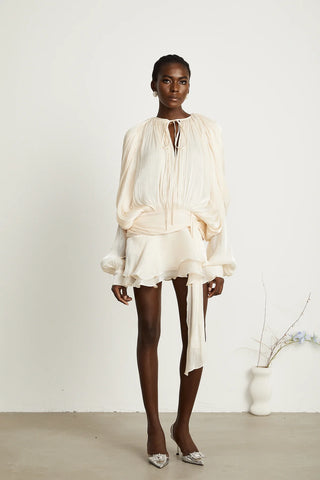 A chic ivory mini dress with long pleated sleeves, a twist waist design, and a ruffled hem, perfect for bridal events or summer occasions. Cielie White ivory mini dress long sleeve chiffon.
