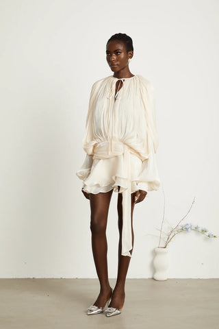 A chic ivory mini dress with long pleated sleeves, a twist waist design, and a ruffled hem, perfect for bridal events or summer occasions. Cielie White ivory mini dress long sleeve chiffon.