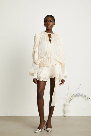 A chic ivory mini dress with long pleated sleeves, a twist waist design, and a ruffled hem, perfect for bridal events or summer occasions. Cielie White ivory mini dress long sleeve chiffon.