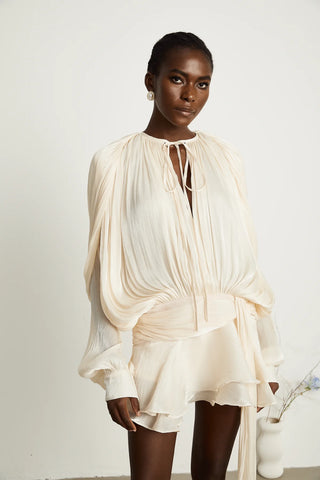 A chic ivory mini dress with long pleated sleeves, a twist waist design, and a ruffled hem, perfect for bridal events or summer occasions. Cielie White ivory mini dress long sleeve chiffon.