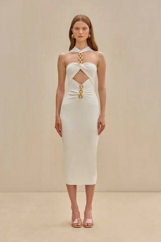 White knit midi dress with gold chain embellishments, bold cutouts, and a halter neckline.