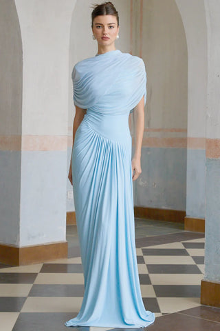 Elegant baby blue asymmetric pleated maxi dress with draped shawl detail, perfect as a wedding guest dress, baby shower dress, or formal evening gown. Sleeveless floor-length blue dress with a figure-flattering fit, ideal for gender reveal parties, spring and summer weddings, and special occasions. Shop this chic and sophisticated pleated maxi dress for a timeless and graceful look.