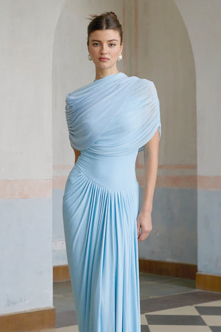 Elegant baby blue asymmetric pleated maxi dress with draped shawl detail, perfect as a wedding guest dress, baby shower dress, or formal evening gown. Sleeveless floor-length blue dress with a figure-flattering fit, ideal for gender reveal parties, spring and summer weddings, and special occasions. Shop this chic and sophisticated pleated maxi dress for a timeless and graceful look. Cielie