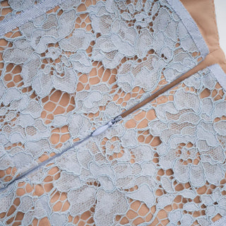 Model wearing baby blue lace midi dress with corset bodice and short lace sleeves