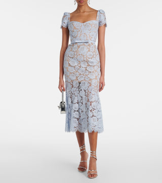 Model wearing baby blue lace midi dress with corset bodice and short lace sleeves