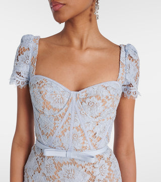 Model wearing baby blue lace midi dress with corset bodice and short lace sleeves
