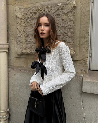 White sequin party top with black bow details