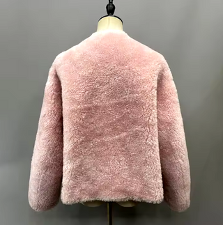 Cropped plush wool fur jacket in soft pink with gold buttons, single-breasted design, cozy teddy coat style for winter. Teddy coat pink