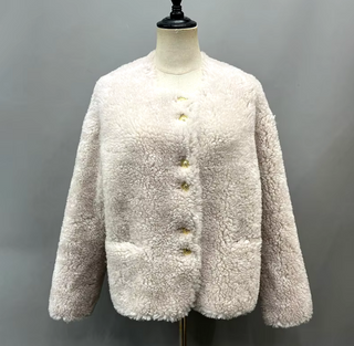 Cropped plush wool fur jacket in soft pink with gold buttons, single-breasted design, cozy teddy coat style for winter. Teddy coat white
