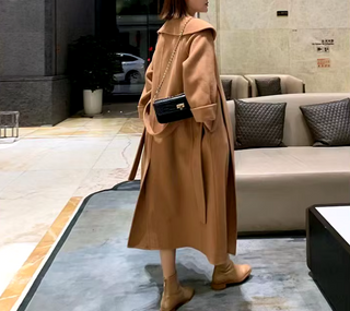 Stylish camel cashmere wool coat with a belted waist and large lapel, showcasing its elegant double-sided design. Camel Max Mara Style Belted