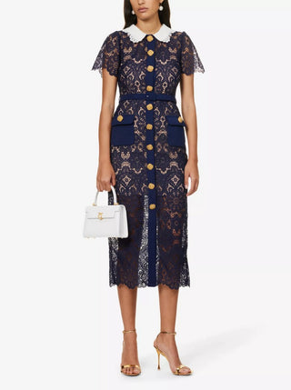 Model wearing navy guipure lace midi dress with white contrast collar and gold buttons. Cielie Vienna Fashion Brand Shopping