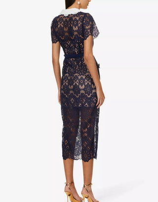 Model wearing navy guipure lace midi dress with white contrast collar and gold buttons Austrian Fashion Brand