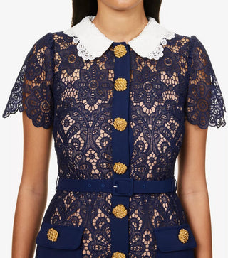 Model wearing navy guipure lace midi dress with white contrast collar and gold buttons Austrian Fashion Brand