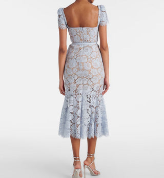 Model wearing baby blue lace midi dress with corset bodice and short lace sleeves