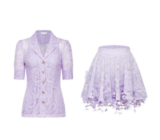 Woman wearing a lavender lace two-piece summer set with short-sleeve buttoned top and floral embroidered flared skirt, perfect for vacation or coastal getaway.