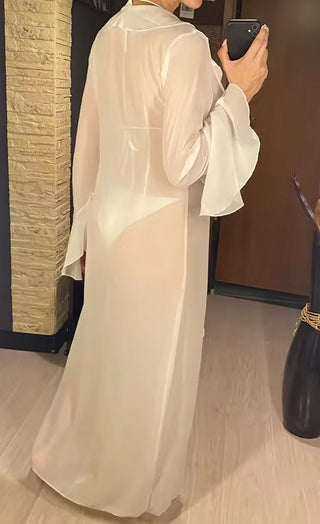 White ruffle mesh beach cover-up with long flared sleeves and front tie closure, styled over a bikini for a boho coastal look by the ocean.