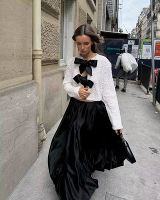 White sequin party top with black bow details
