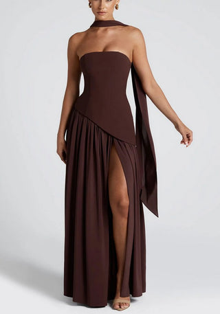 Model wearing espresso brown strapless maxi dress with crepe bodice, white chiffon skirt, thigh-high slit, and matching chiffon scarf.