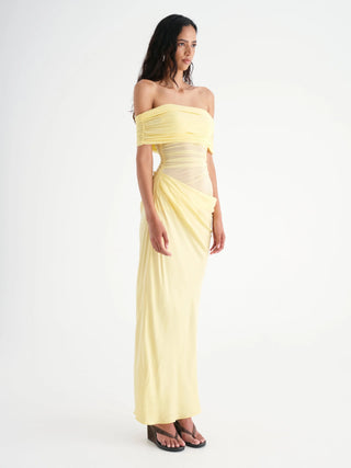 Woman wearing a yellow strapless gown on a white background