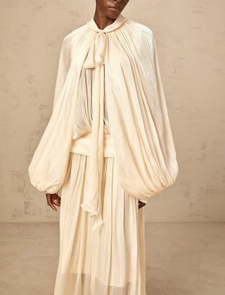 Elegant ivory satin gown styled for modern modest bride – long sleeve wedding maxi dress with flowing silhouette.