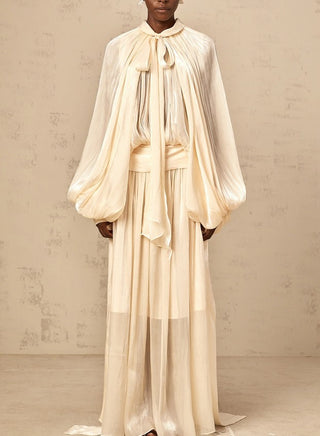 Elegant ivory satin gown styled for modern modest bride – long sleeve wedding maxi dress with flowing silhouette.