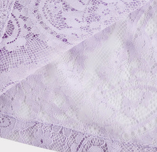 Woman wearing a lavender lace two-piece summer set with short-sleeve buttoned top and floral embroidered flared skirt, perfect for vacation or coastal getaway.