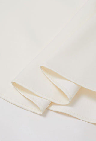 Elegant white midi dress with bow shoulder details, crystal buttons, and side pockets, perfect for bridal showers, engagement parties, rehearsal dinners, and cocktail events. A-line silhouette ideal for bridal and cocktail events. Cielie Vienna Fashion Brand Rental Gown