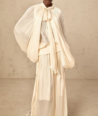 Elegant ivory satin gown styled for modern modest bride – long sleeve wedding maxi dress with flowing silhouette.