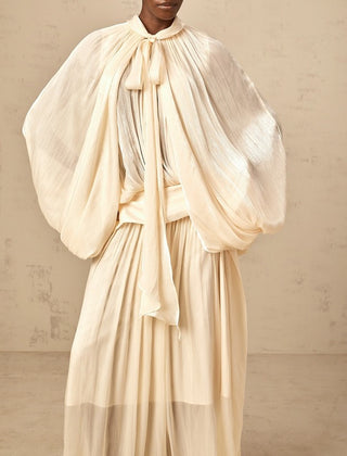 Ivory modest wedding dress with dolman sleeves and floor-length pleated satin skirt – perfect for formal bridal occasions.