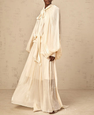 Elegant ivory satin gown styled for modern modest bride – long sleeve wedding maxi dress with flowing silhouette.
