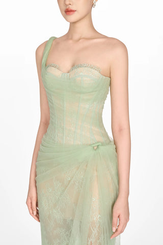 Model wearing a soft green tulle lace dress with asymmetrical one-shoulder strap, fitted bodice, and draped skirt, perfect for summer weddings and special occasions. Bridesmaids Sage green dress