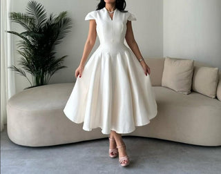 Ivory midi dress with pleated skirt – perfect for minimal bridal or rehearsal