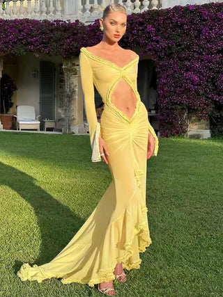 Model wearing a sheer yellow mesh beach dress with cut-out front and volant sleeves – perfect for summer vacations or beach cover-ups.