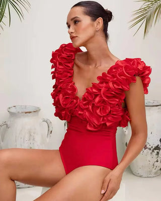 Red ruffled two-piece beach set featuring a bikini with a matching asymmetric skirt. Stylish swimsuit and cover-up combination in polyester/spandex for a bold, elegant beachwear look. Cielie Vienna
