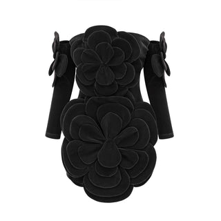 Model wearing a black velvet off-the-shoulder dress with large floral appliqué detailing and matching gloves, perfect for holiday parties, Christmas, and New Year's celebrations.