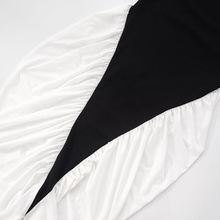 Black triangle-shaped object on a white textured surface