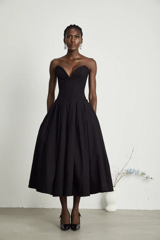 Elegant black strapless corset midi dress with pleated skirt, V-neckline, and off-the-shoulder design. A chic dupe for House of CB dresses, perfect for formal events and cocktail parties. Cielie Vienna Lady