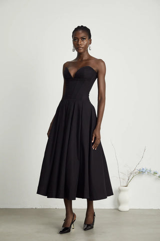 Elegant black strapless corset midi dress with pleated skirt, V-neckline, and off-the-shoulder design. A chic dupe for House of CB dresses, perfect for formal events and cocktail parties. Cielie Vienna Lady