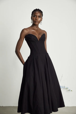 Elegant black strapless corset midi dress with pleated skirt, V-neckline, and off-the-shoulder design. A chic dupe for House of CB dresses, perfect for formal events and cocktail parties. Cielie Vienna Lady