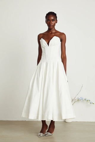 Elegant strapless white midi dress with corset-style bodice and pleated skirt, a chic House of CB dupe. Perfect as a minimalist bridal dress, with vintage-inspired elegance for weddings and formal events.