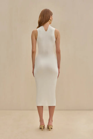 White knit midi dress with gold chain embellishments, bold cutouts, and a halter neckline.
