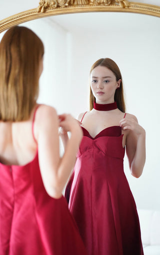 Stunning wine red cocktail dress with velvet choker and flare midi skirt. Ideal for formal events, parties, and available for ball gown rental in Vienna.