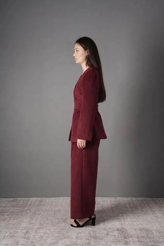 Front view of the Voera Wool Suit 2-Piece Blazer Pants Set in Burgundy, featuring a tailored blazer with belt and wide-leg trousers.