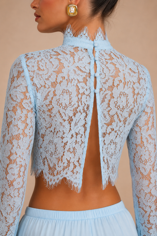 Back view of AULA baby blue floral lace crop top featuring open back button detail with matching satin wide leg trousers, elegant European vacation outfit for beach clubs and luxury summer holidays.