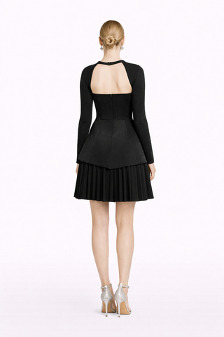 Black dress with long sleeves and pleated skirt on a white background