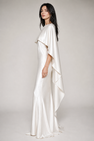 Woman wearing a flowing white dress bridal maxi satin white dress