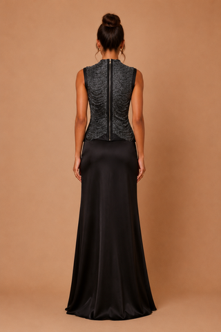 Elegant black two-piece set featuring a ruched high-neck shimmer top and satin maxi skirt, modest wedding guest outfit, luxury eveningwear, formal occasion co-ord.