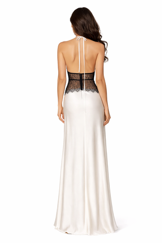 White evening gown with black lace detailing on a white background