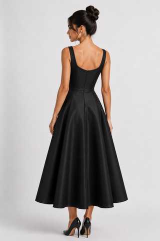 Woman wearing a black sleeveless dress on a white background
