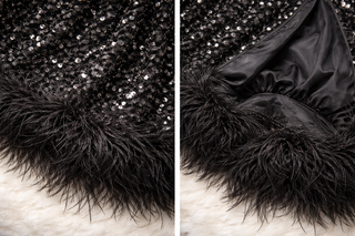Black sequin fabric with feather trim on a textured surface